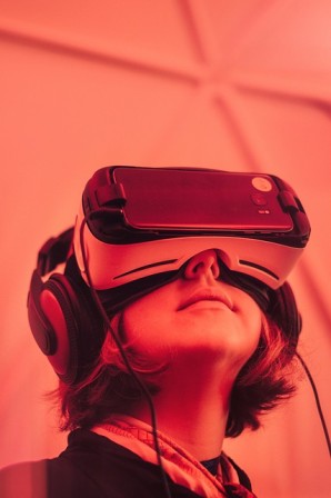 Person wearing a VR headset and headphones, illustrating VR/AR used to review product concepts before build