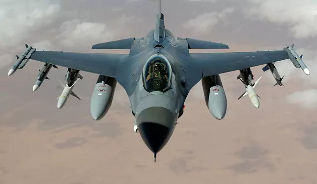 Fighter jet in flight carrying external stores, illustrating the airfoil optimization case study