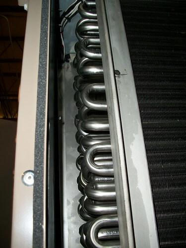 Stainless steel evaporator coil tubes inside an air conditioning unit