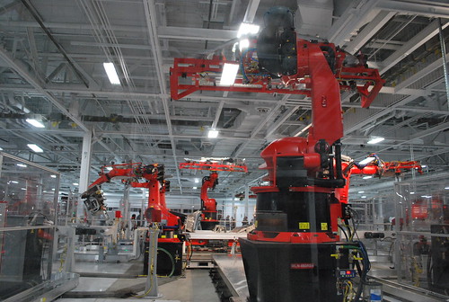 Industrial robots on a vehicle assembly line, illustrating where product design hands over to manufacturing at scale