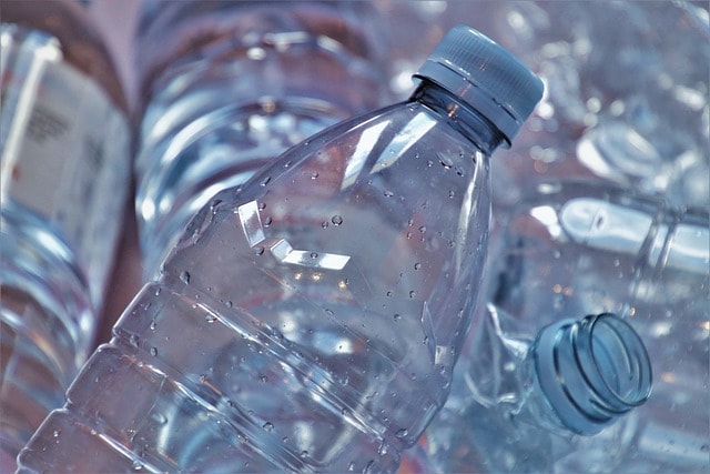Close-up of empty plastic water bottles, illustrating packaging waste targeted by recycling programs