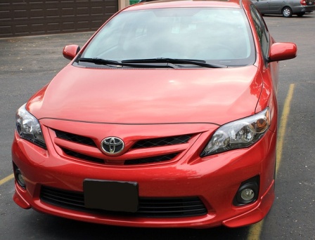 Red Toyota Corolla sedan, front view, an example of design for reliability built into a car from the start