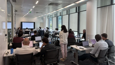 Engineers working on laptops in a training room during a hands-on Neural Concept Bootcamp session