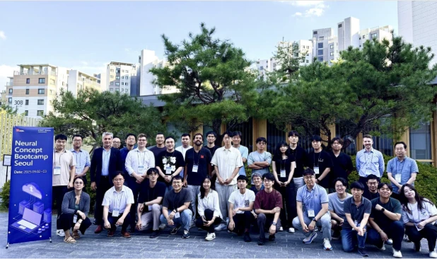 Group photo of Neural Concept Bootcamp Seoul participants outdoors beside the event banner